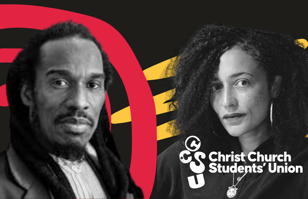 A black and white portrait of two people of colour looking at the camera.