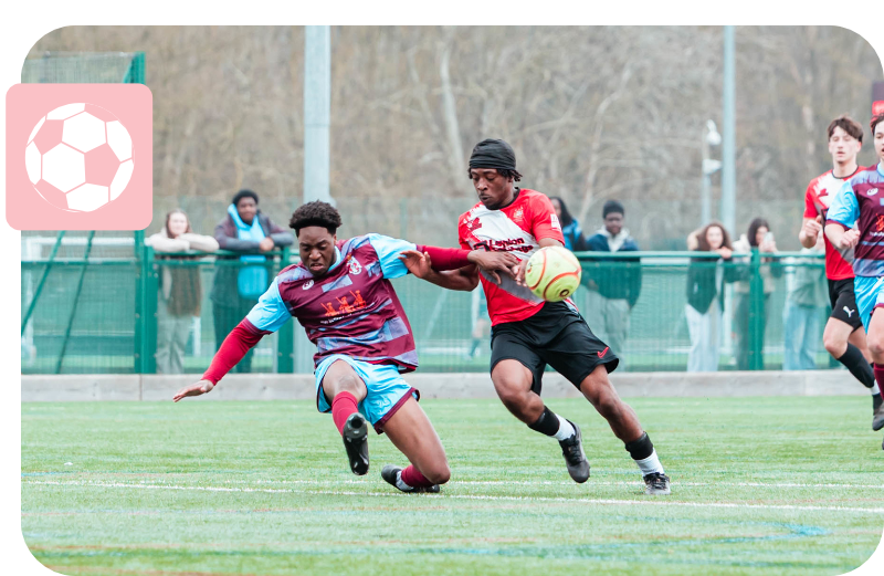 Two football players in the middle of a tackle for the balle on a field outside.